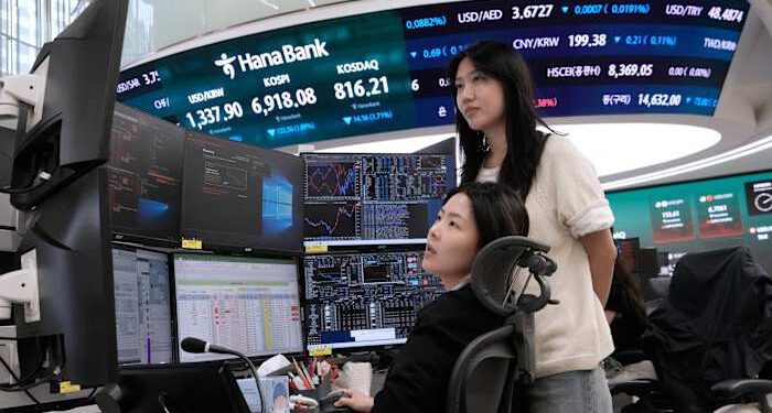 Asian shares fall and oil prices hold steady above $100 a barrel